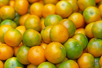 Orange fruit in crate on rustic wooden table background.