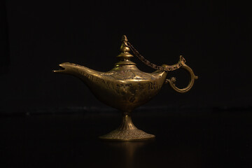 Aladdin's magic lamp isolated on black background