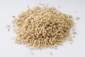 raw unpolished rice on a white acrylic background