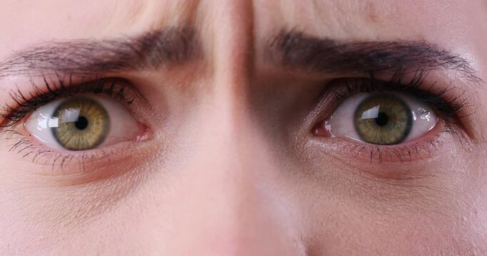 Emotional woman seeing something terrifying, closeup view