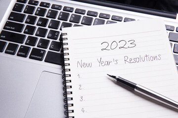 conceptual,New year's resolutions in notebook with pen on laptob