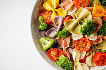 delicious colored farfalle pasta on a white background