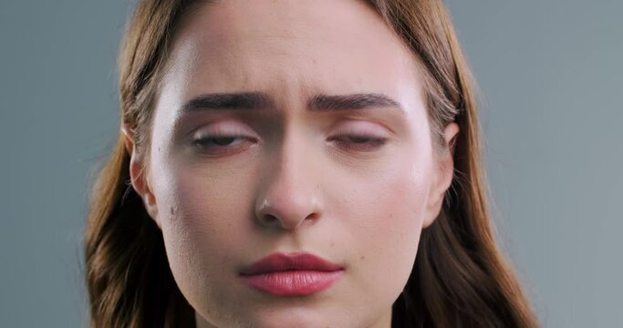 Beautiful sad woman on light grey background, closeup