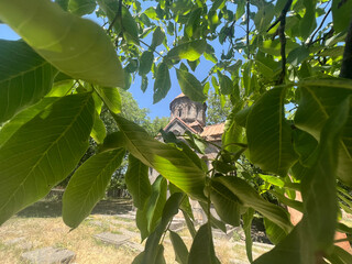 Small little monastery between trees in Armenia