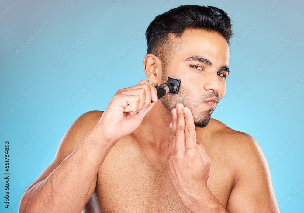 Poster Man, shave and razor for wellness, skincare and cosmetics against blue studio background. Indian male, beard and shaver for natural beauty, smooth and clear skin for treatment, routine and grooming.