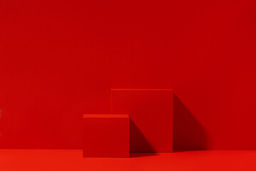 Red scene for product presentation, red podium with copy space. Front view, studio photography.