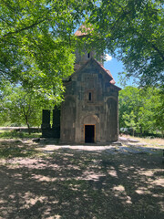 Small little monastery between trees in Armenia