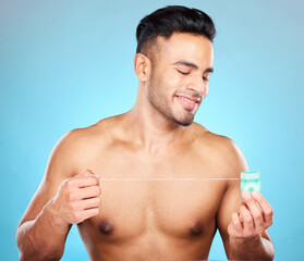 Man, body or dental floss for grooming, mouth hygiene maintenance or plaque removal help on blue...