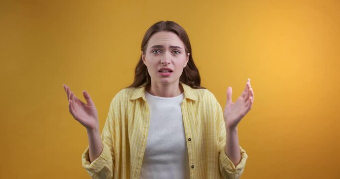 Young woman full of hope becoming sad on light blue background