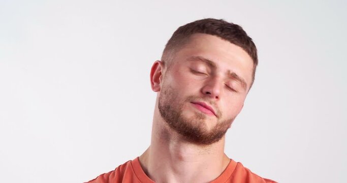 Emotional bearded young man on light background