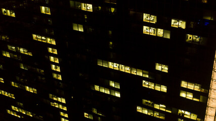 Fototapeta premium Aerial night view of an office building. The lights are on.