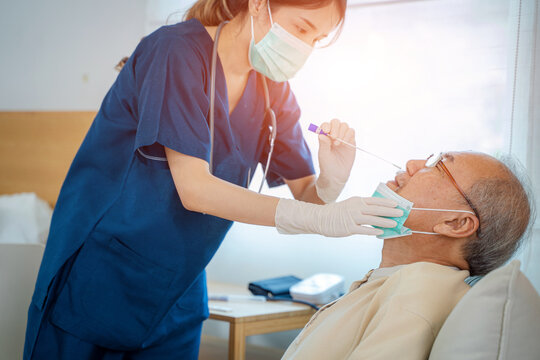 Nurse Performing Coronavirus Test On Senior Man At Nursing Home.