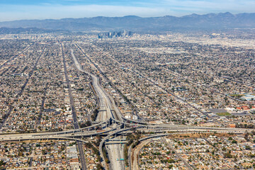 Aerial view of highway interchange Harbor and Century Freeway traffic with downtown Los Angeles, USA