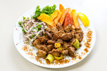 Beef steak grill with rice pilaf, fried potatoes, grilled pepper and tomatoes.Mix Platter with Beef rips, Cutlets, Potatoes and Sauces.