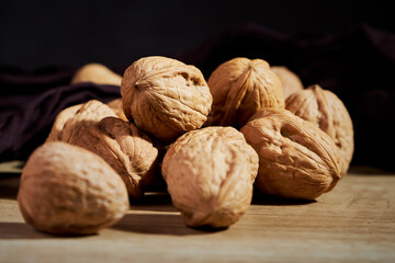 Close-up of tasty in-shell walnuts on wooden table