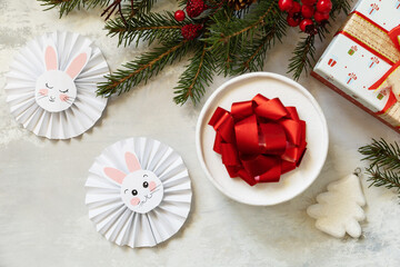 Merry Christmas and Happy Holidays greeting cards New Year. Christmas tree, gifts boxs and symbol of year lunar chinese calendar, year of the rabbit. View from above. Copy space.