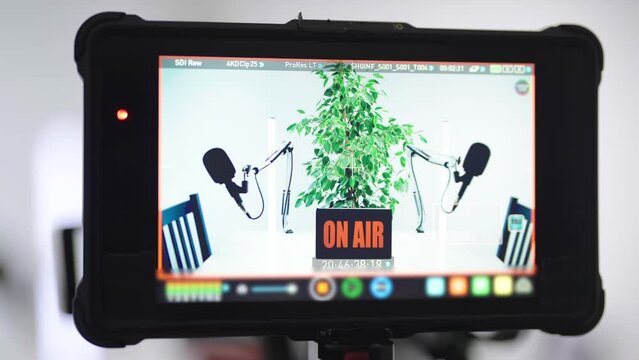 Bright White Podcast Studio With Green Flower From Behind The Camera Zoom Out 4K