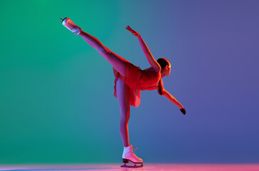 Young sportive girl, junior female figure skater in red stage costume skating isolated over gradient green-blue background in neon light. Grace, beauty, winter sports - obrazy, fototapety, plakaty