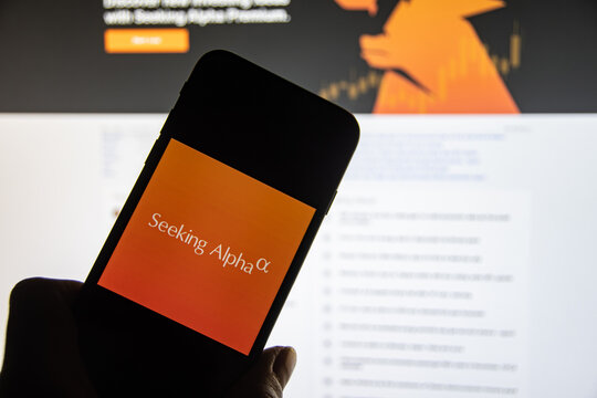 Rheinbach, Germany  5 December 2022,  The brand logo of the company "Seeking Alpha" on the display of a smartphone in front of the website (focus on the brand logo)