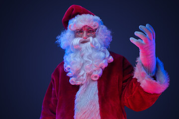Portrait of santa claus dressed in red costume staring at camera.