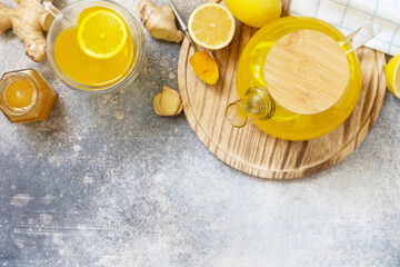 Healthy organic vegan drink. Antioxidant ginger turmeric lemon tea with honey on a stone table. Winter tea, Immunity boosting drink. View from above. Copy space.