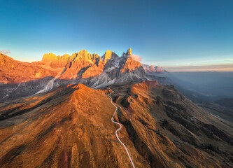 Pale di San Martino mountains during sunset. Aerial view. Rolle Pass, Trento Province, South Tyrol, Italy. - 551780460