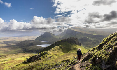 Woman hiking on Quiraing.It is a geological formation on the Scottish Isle of Skye and a hiker's paradise
