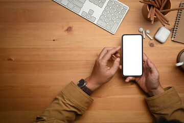 From above view of man holding smart phone with empty screen.Copy space, blank screen for advertise design