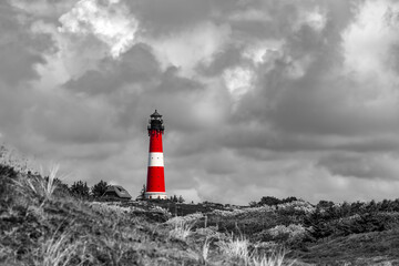 Lighthouse of Hörnum on Sylt island Germany. Red and white tower with dunes. Landmark, sight and...