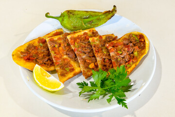 Kiymali pide. Turkish pide with minced meat. Turkish pizza mince pita Pide on white background. Etli ekmek. Kusbasili pide.