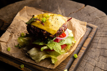 Burger with beef patty, cheese, lettuce and tomato