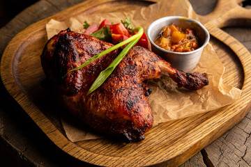 Baked chicken drumstick with vegetable salad and sauce