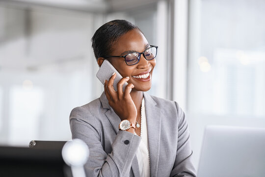 Successful African Business Woman Talking On Phone In Office