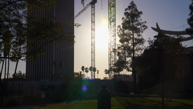 Walking through the Los Angeles County Museum of Art (LACMA) during sunset with buildings and infrastructure in the background on a sunny California day.