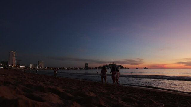 Mazatlan Sinaloa beach at night with luminous city in the background