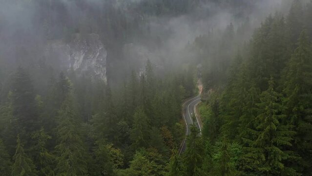 Bicaz pass mountain road high up in the Carpathian Mountains in Romania on a foggy autumn day