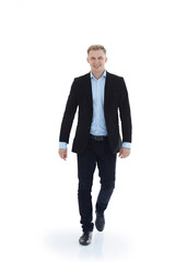 in full growth.a young man in a business suit striding forward .