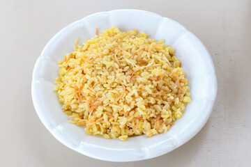 Traditional turkish bulgur pilaf with tomato sause in plate (Turkish name; bulgur pilavi, meyhane pilavi) Pirinc pilavi. Pilavustu tavuk, nohut, kuru fasulye, ciger.
