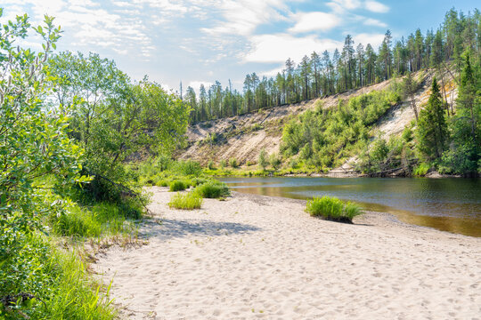 A view to a sandy beach, river Oulanka (Oulankajoki) and sand esker on a sunny summer day in Oulanka National Park, Northern Finland
