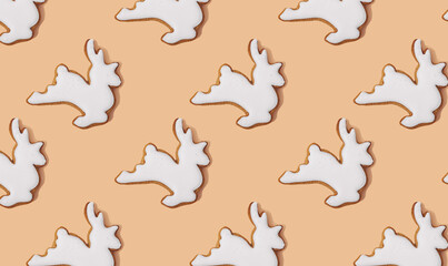 Happy holidays, Merry Christmas, New Year, seamless pattern. White deer shaped gingerbread cookie on pastel orange, minimal print for new year card