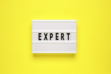 Lightbox with word expert on yellow background. Can be used for business and financial concepts.