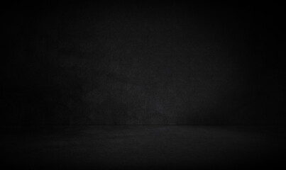 Empty dark three dimensional room with black concrete wall and floor and a low lighting