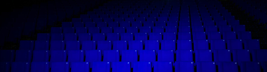 Obraz premium empty cinema theater with blue seats in the dark