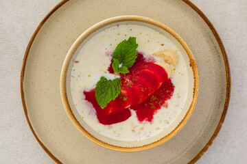 Portion of healthy sweet porridge with banana and jam