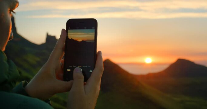 Woman photographer, photography of sunset on smartphone and silhouette of mountains in Brazil vacation. Landscape view of nature, sky on the horizon and record memory of travel lifestyle on calm day