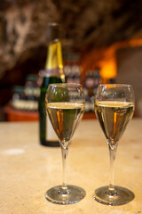 Tasting of rose champagne sparkling wine produced by traditional method in underground caves in Champagne, France