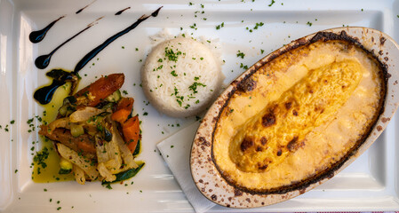 Quenelle, speciality of Lyon, oval-shaped dumplings filled with pike white fish served in creamy...