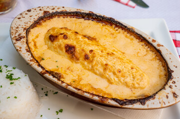 Quenelle, speciality of Lyon, oval-shaped dumplings filled with pike white fish served in creamy sauce in traditional Lyonnaise Bouchon, France