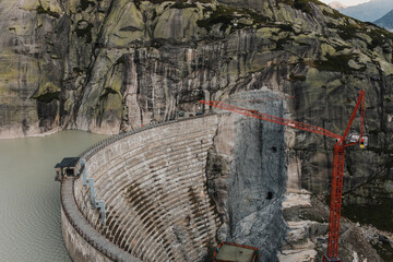 Dam construction in Grimsel Lake, Switzerland. - 551797247