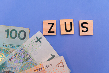 inscription ZUS next to Polish money. ZUS is a Zakład Ubezpieczeń Społecznych. retirement...